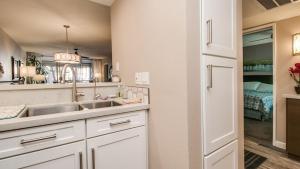 a kitchen with a sink and a bedroom at Cozy 2-Bdrm Condo in Heart of Old Town Scottsdale in Scottsdale +26 photos
