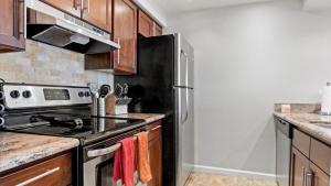 a kitchen with a stove and a refrigerator at Charming 2Bd-2Bth in Heart of Old Town Scottsdale in Scottsdale