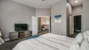 a bedroom with a bed and a flat screen tv at 3 Bdrm Townhouse WGarage in Gated Complex in Phoenix