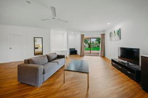 a living room with a couch and a tv at The Kimberley Grande Resort in Kununurra