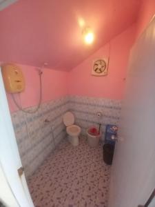 a bathroom with a toilet in a pink room at Blue Sky Resort in Ko Chang