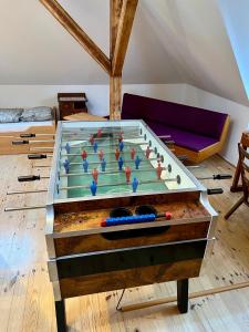 a foosball table in a living room with at Retro Villa Prague 700sqm Indoor-Pool, Sauna, BBQ, table soccer in Prague