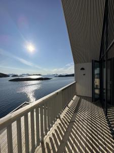 a balcony of a building with a view of the water at CornerView Apartment Henningsvær in Henningsvær
