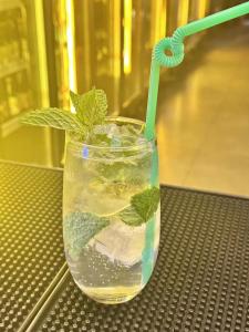 a glass of water with a green plant in it at Dayin International Youth Hostel East Nanjing Road & The Bund in Shanghai