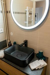 lavabo negro en el baño con espejo en Magnifique Appartement de 3 chambres, en Annecy