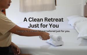 a woman putting a clean retrieval box on a bed at Ocean Breeze Hostel by Daily Sweet in Moalboal