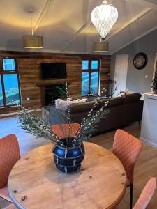 a vase on a table in a living room at Woodside Lodge, Weybourne, Holt in Weybourne