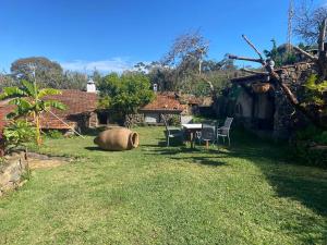 einen Garten mit Tisch und Stühlen und ein Haus in der Unterkunft Rural House to take a Break, La Serreria 25 in Tacoronte