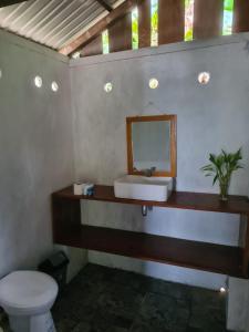a bathroom with a sink and a toilet at Pondok Lestari Kadidiri in Batudaka