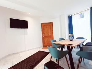 a conference room with a table and chairs and a television at central 3 Bedroom Apartment in Kreuzberg in Berlin