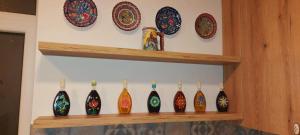 a shelf with vases and plates on a wall at Merlot Apartment in Cricova