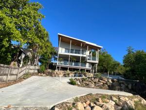 a large house with a lot of windows at The Orchid Suite - Apartment in Cooktown in Cooktown