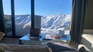 a living room with a view of a mountain at Mariam's Stunning and Sunny Apt in Gudauri