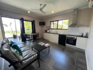 a living room with a couch and a table at The Frangipani Suite - One bedroom apartment in Cooktown in Cooktown