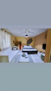 a living room with two tables and a ceiling at LOFTY DIANI STUDIO'S in Kwale