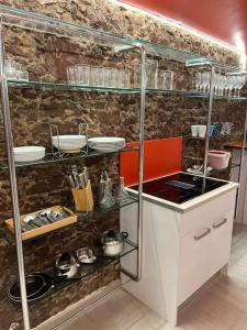 a kitchen with a counter and shelves with dishes at ! Especial y singular ! Directo Fira BCN y CENTRO in Martorell