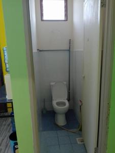 a small bathroom with a toilet with a window at Irman Homestay Pendang in Pendang +8 photos