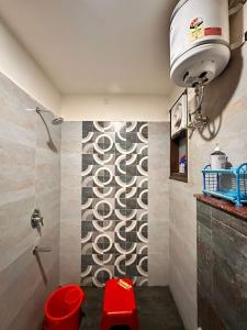 a bathroom with a shower with a wall at Yoga Retreat at The Ganges in Rishikesh in Rishīkesh