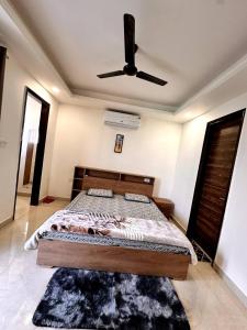 a bedroom with a bed with a ceiling fan at Yoga Retreat at The Ganges in Rishikesh in Rishīkesh
