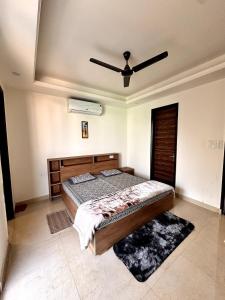 a bedroom with a bed and a ceiling fan at Yoga Retreat at The Ganges in Rishikesh in Rishīkesh