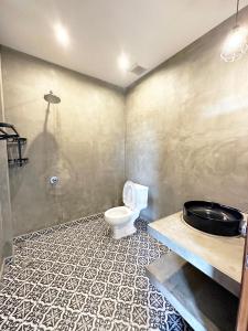 a bathroom with a toilet and a sink at Eco Inn in Phumĭ Réach Born
