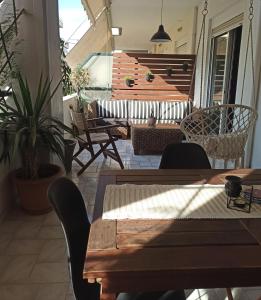 a patio with wooden tables and chairs and stairs at Deluxe Lodge in Volos