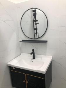 a bathroom with a sink and a mirror at SKYN SMART HOME in Ipoh