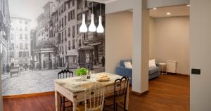 a dining room with a table and a mural of a city at Casa di Ravecca in Genoa