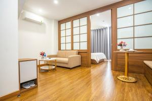 a living room with a couch and a chair at Sumitomo 15 Apartment - No 27 Lane 39 Linh Lang Street in Hanoi