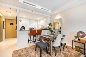 a dining room and kitchen with a table and chairs at Stylish 2BR at Paramount Hotel Midtown in Dubai