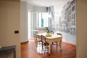 a dining room with a table and chairs with a mural at Casa di Ravecca in Genoa