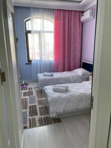 a room with two beds and a window at Tashkent hotel Parvoz in Tashkent