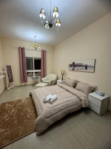 a bedroom with a large bed and a living room at Your Dubai delight in Dubai