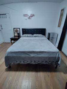 a large bed in a bedroom with a wooden floor at Cozy, spacious and peaceful in Providence