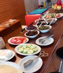 a buffet with plates of food on a table at Kanakis Blue Beach Apartments in Petres
