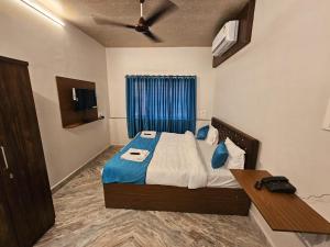 a bedroom with a bed and a ceiling fan at PRIME VISTA in Navi Mumbai +4 photos