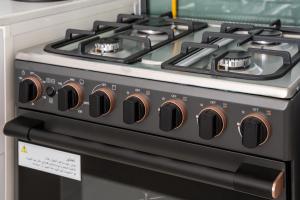 a black and white stove top oven in a kitchen at Newly Built Luxury Apt - Pool in Dubai