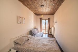 a bedroom with a bed and a wooden ceiling at Valtesiniko View in Valtessiniko 