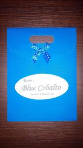 a blue card with a surfboard and a bow tie at Antico Centro Quartu B&B in Quartu SantʼElena