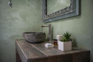 a bathroom with a bowl sink on a wooden table at Gorianades Traditional House in Gorianádhes