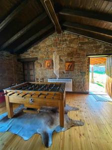 a wooden table in a room with a stone wall at La Casa de Roma 