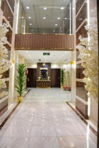 a lobby of a hotel with a hallway with plants at فندق المرزم-Al Marzam Hotel in Al Madinah