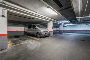 a van parked in a parking lot in a parking garage at Luxury Plaza De Castilla in Madrid