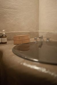 a bathroom counter with a sink and a mirror at kamenos Luxury Resort With Beautiful Scenery Hiji in Hiji