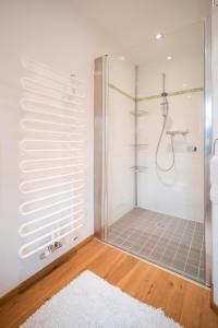 a bathroom with a shower with a glass door at Altes Bauernhaus von 1756 - Villa Straussengut in Bad Aussee +40 photos