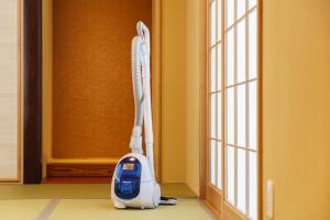 a vacuum cleaner in a room next to a window at Chachamaru no Oyado - Vacation STAY 85728 in Yufuin