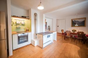 a kitchen and dining room with a table and chairs at Altes Bauernhaus von 1756 - Villa Straussengut in Bad Aussee