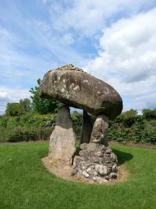 a stone mushroom statue in a field of grass at Sunny Rooms near town centre in Warrenpoint
