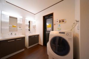 a washing machine in a bathroom with two sinks at Takanoya Hoshi - Vacation STAY 91923 in Yufuin