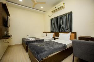a hotel room with two beds and a window at THE PARK AVENUE HOTEL - Business Class Hotel Near Central Railway Station Chennai Periyamet in Chennai
